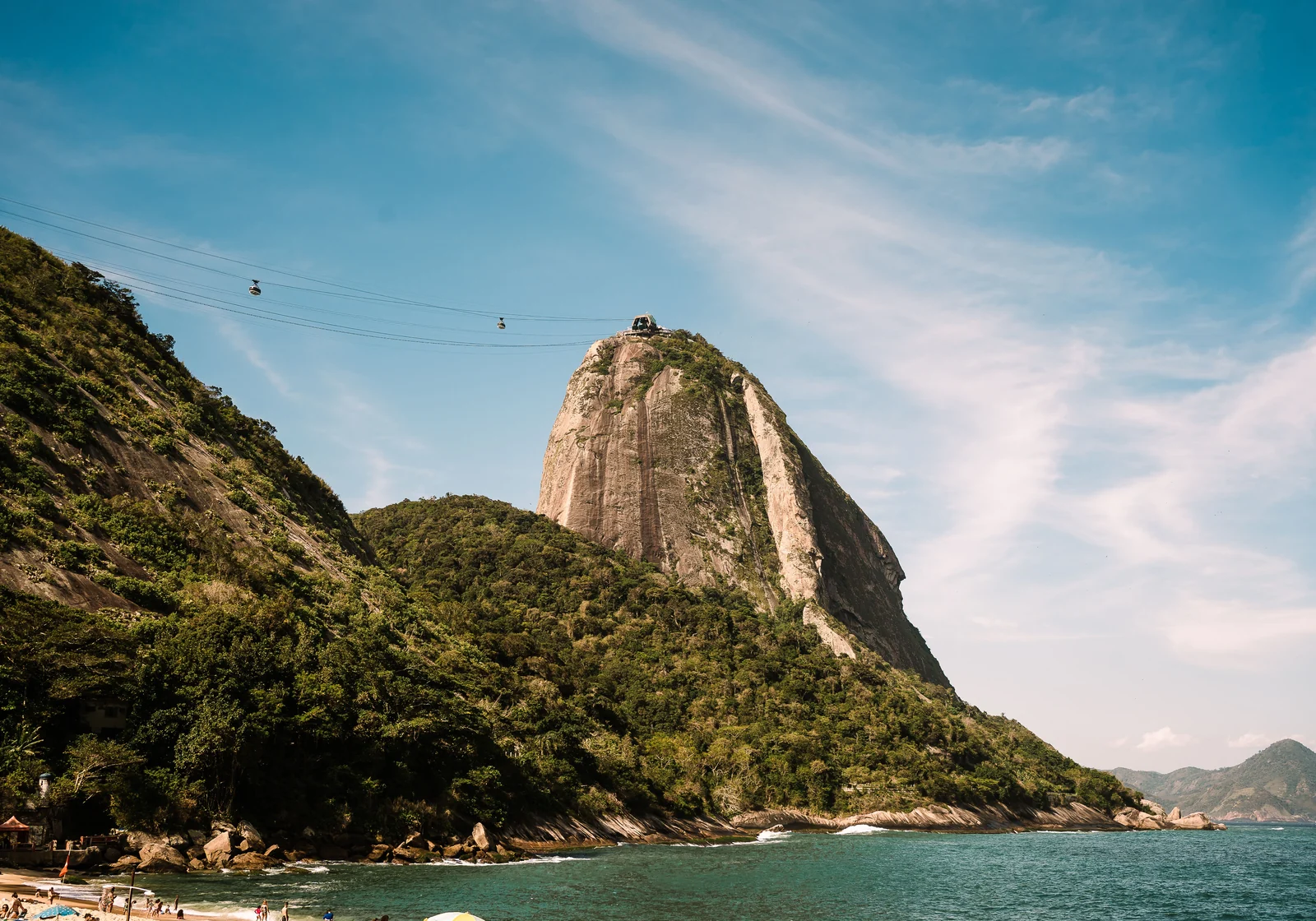 Sugarloaf cable car ascending over Guanabara Bay at sunset