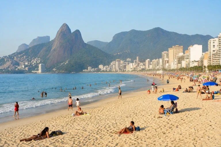 Rio de Janeiro beach with ocean, sand, mountains, and the city skyline
