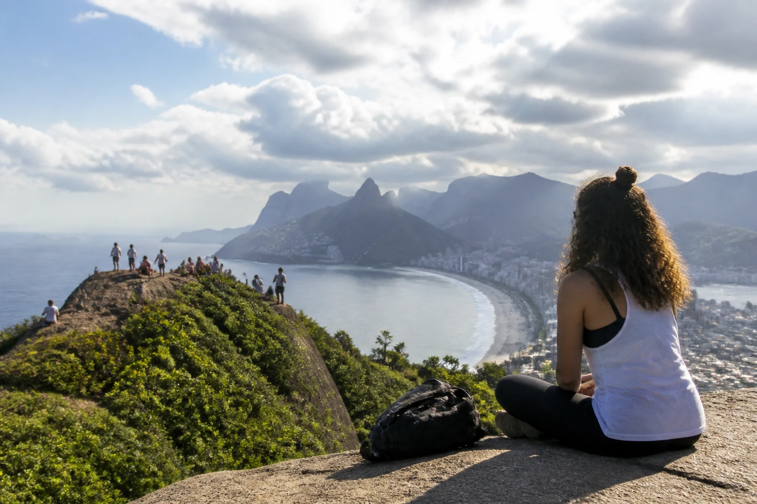 Travelers walking beside the Rio de Janeiro coast on a winter day