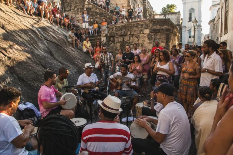 An outdoor samba roda beside the historic stone slope at Pedra do Sal in Rio de Janeiro