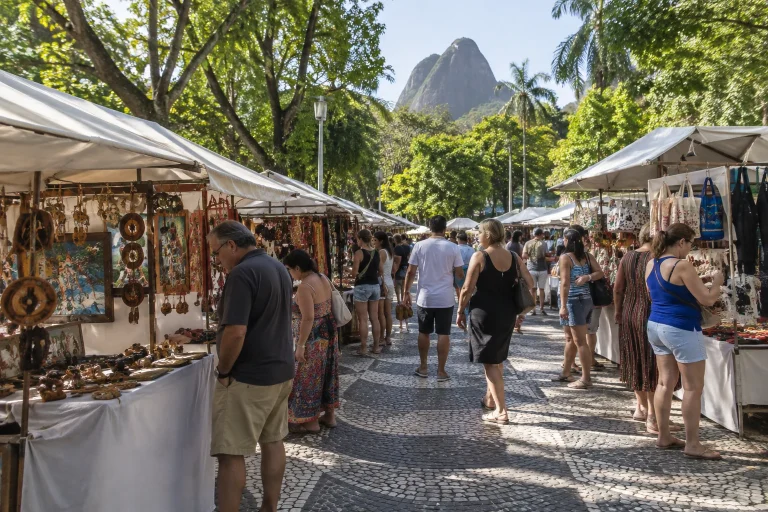 Visitors browse handmade craft stalls at Feira Hippie de Ipanema in Rio de Janeiro.