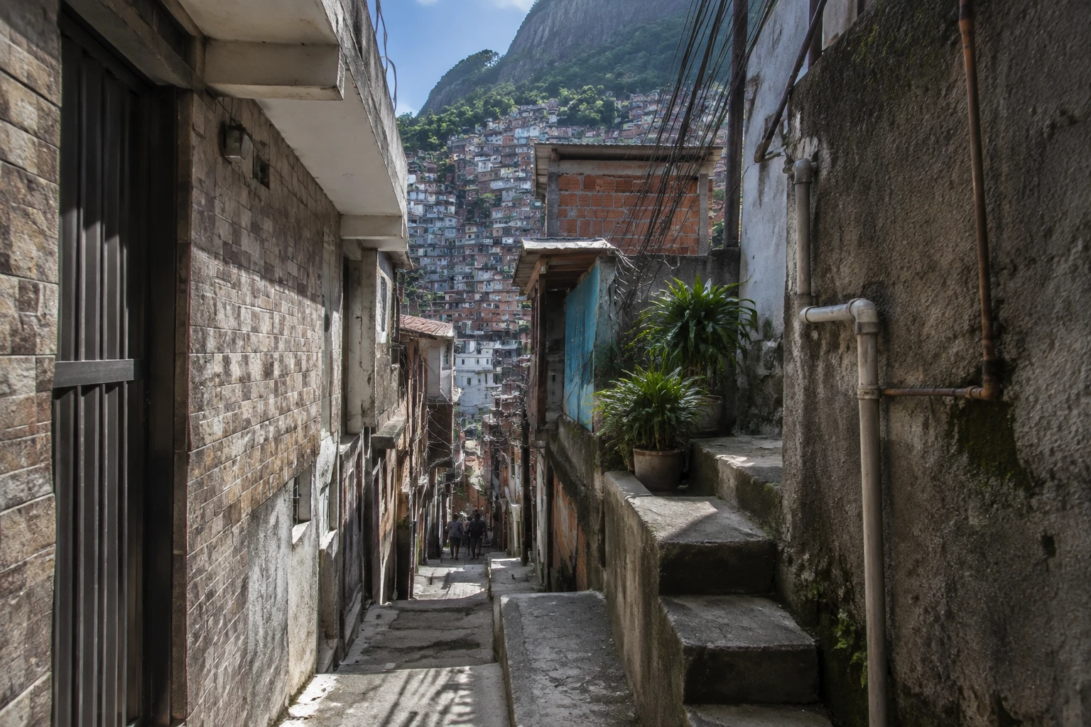 Narrow walking lane with sloping pavement in Rocinha, Rio de Janeiro